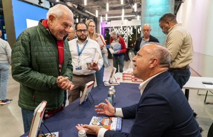 Mike Madrid signs copies of his book, 'The Latino Century: How America's Largest Minority Is Transforming Democracy,' published in June 2024.